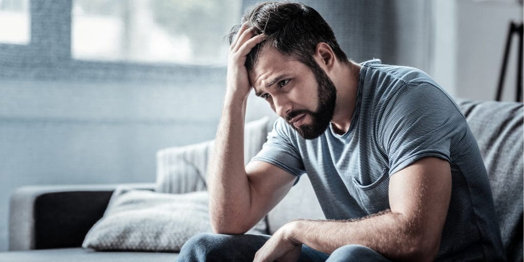 A man dealing with passive suicidal thoughts, looking forward contemplatively.