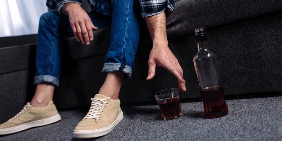 Man reaching out the alcohol drink on the floor - Illustration