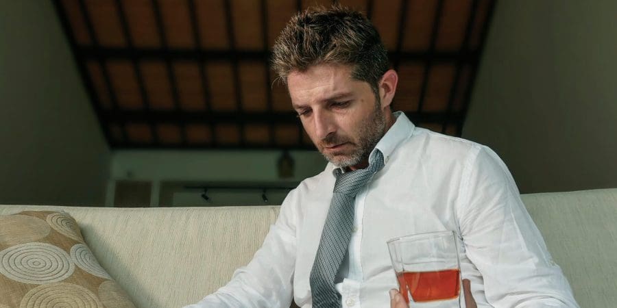 man drinking alcohol having mental break