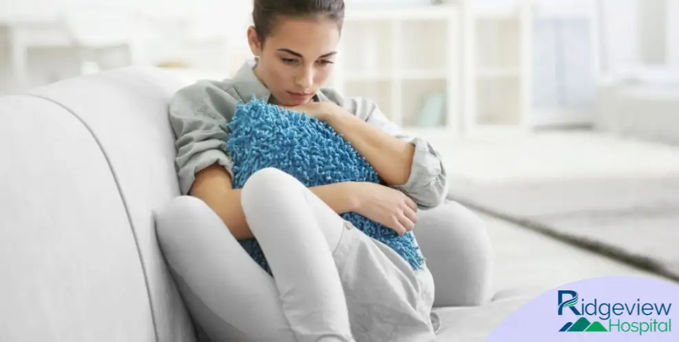 woman with depression laying on the couch